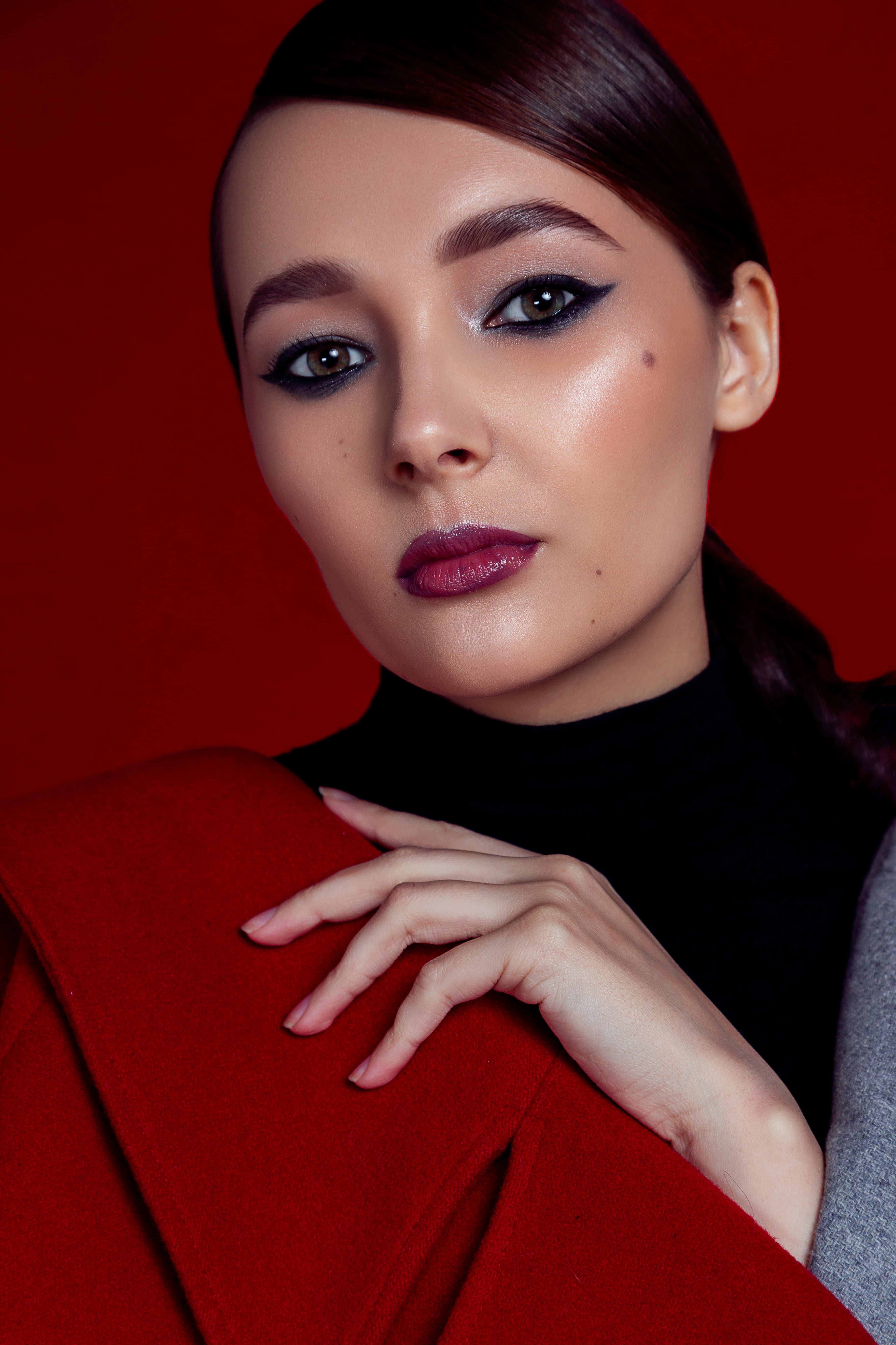 Beauty portrait with electric blue winged eyeliner and metallic bronze lips